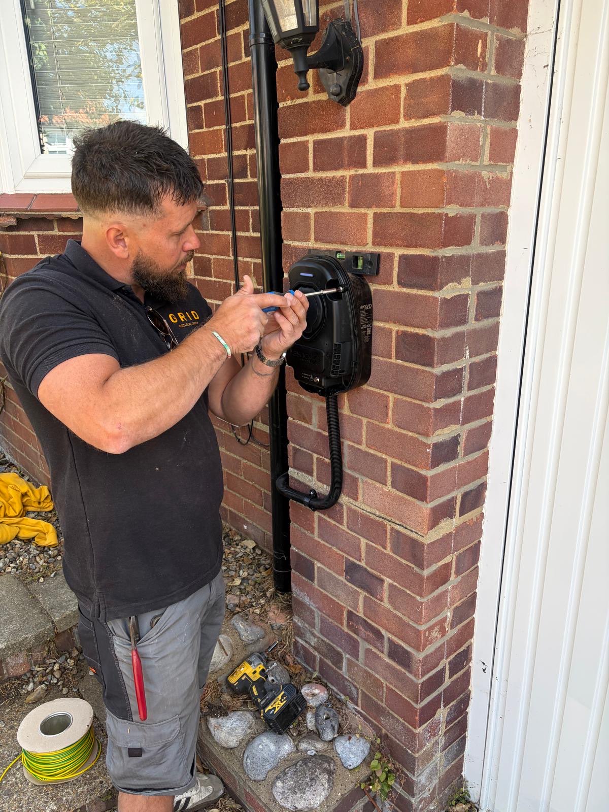 GRID engineer fitting an EV charge point